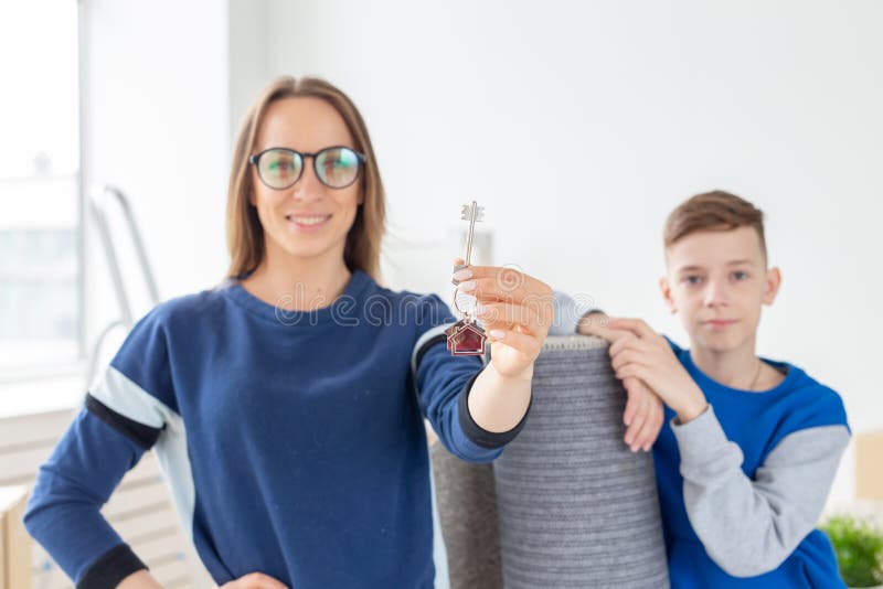 Blurry Good Looking Mom And Son Are Holding The Keys To A New Apartment