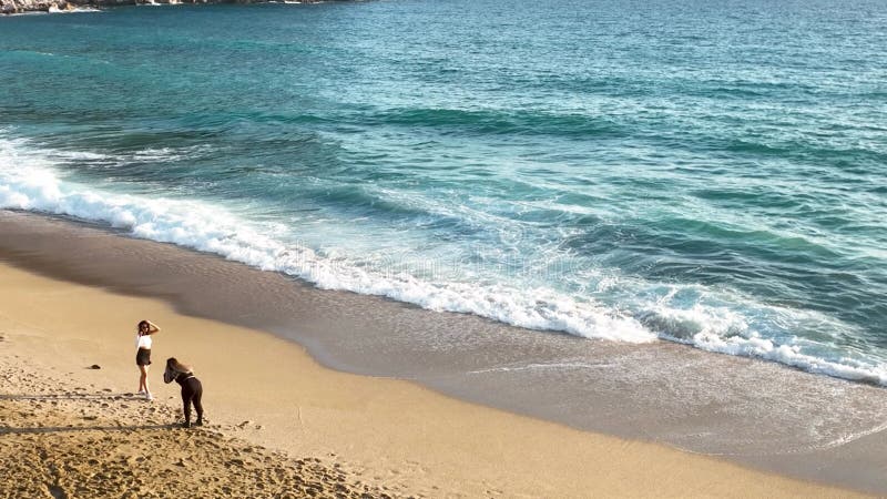 Girls Take Pictures On The Beach Aerial View 4 K Stock Footage Video