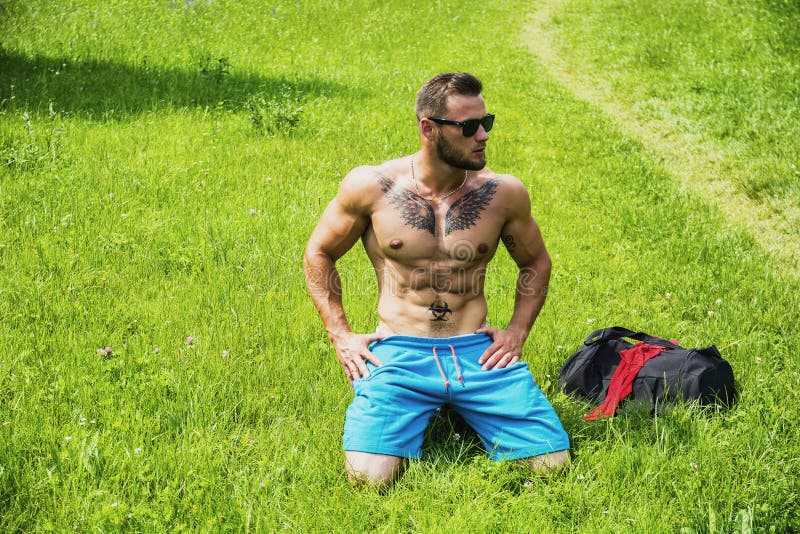 Handsome Muscular Shirtless Hunk Man Outdoor In City Park Stock Photo