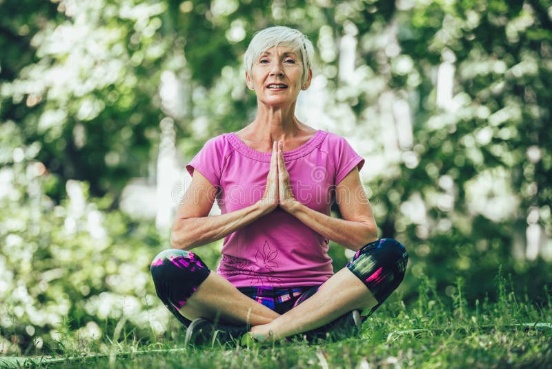 Mature Woman Practicing Yoga In Park Active Lifestyle Stock Image