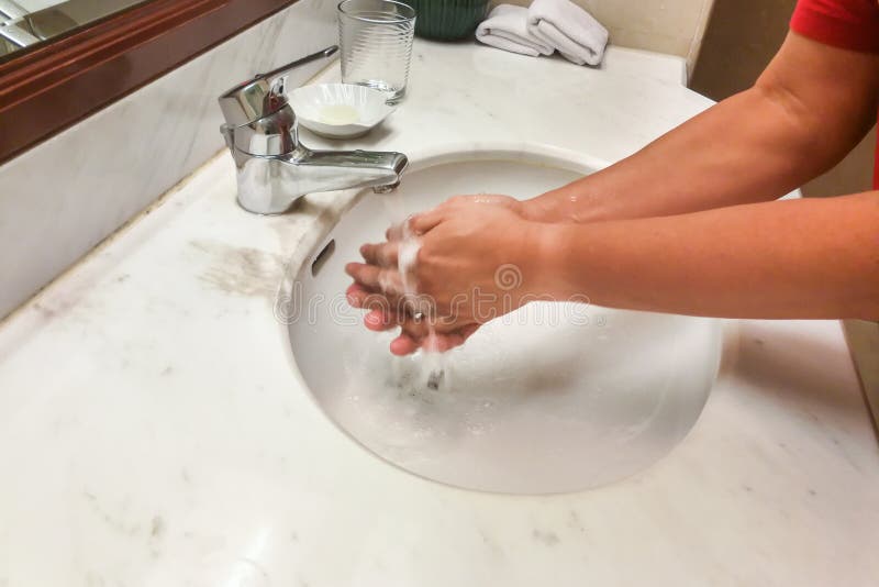 Person Washing Hands With Running Water From Tap Faucet Stock Photo