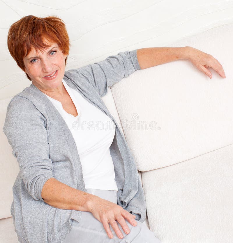 Smiling Middle Aged Mature Woman Looking At Camera At Home Stock Photo