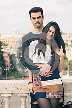Beautiful embracing lovely young italian couple outdoors