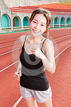 Chinese woman jogging at stadium