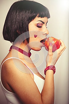 Eating a red apple. Young woman love for fruits.