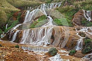 Golden waterfall on a mountain