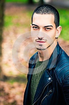 Handsome young man outdoors, short hair style