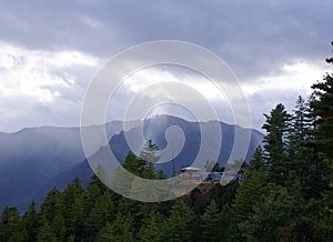 Rays of sun light cracking through the clouds onto mountain peaks