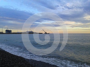 Seaport Sochi, sea and clouds at sunset