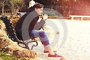 Thinking, thoughtful handsome man on the bench. Outdoors