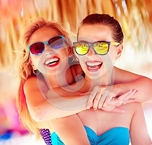 Two beautiful young girls having fun on beach during summer vaca" border="0