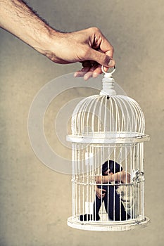 Violence against women. Woman in cage. Deprivation of liberty.
