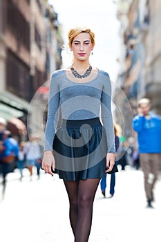 Young girl walking in the city. Youth fashion.