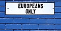 Apartheid sign europeans only blue brick wall