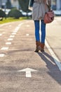 Arrow sign on tarman and woman legs