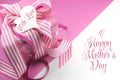 Beautiful pink gift on pink and white background with sample text and copy space for your text here for Mothers Day