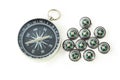 Big compass with ten black small compasses