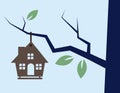Birdhouse hanging from a tree branch Stock Photo