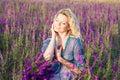 Blond woman in violet field joyful young blooming Stock Photography