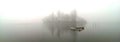 Boat on misty lake