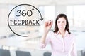 Businesswoman drawing a 360 degrees Feedback concept on the virtual screen. Office background.