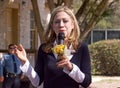 Chelsea Clinton talks with flowers in hand