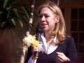 Chelsea Clinton talks outdoor with flowers in hand