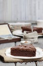 Chocolate cake on white plate, on hessian