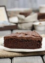 Chocolate cake on white plate, on hessian