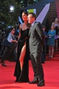 Christian Slater and Sofia Arzhakovskaya smile and pose for photos.