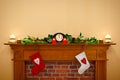 Christmas stockings and garland on a mantlepiece