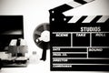Clapper board with vintage movie editing desktop in black and wh