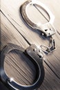 Closed Handcuffs On A Wooden B...