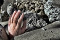 Dead Man Hand in Rubble after Earthquake Disaster