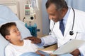 Doctor Visiting Child Patient On Ward