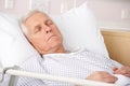 Elderly man sleeping in hospital bed Stock Photography