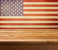 Empty wooden deck table over USA flag background. Independence day, 4th of July background.
