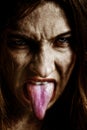 Evil scary sinister woman with tongue out