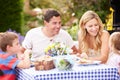 Family Enjoying Outdoor Meal I...