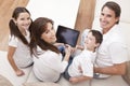 Family Having Fun Using Tablet Computer At Home