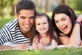 Family Relaxing In Summer Garden