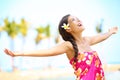 Free happy elated beach woman in freedom joy concept