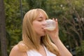 Girl Drinking Milk On The Nature