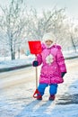 The girl with a shovel for snow