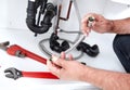 Hands Of Plumber With A Wrench.