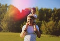 Happy father with son having fun outdoors, sunny summer day