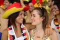 Happy German women sport soccer fans celebrating victory.