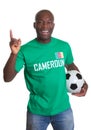 Happy soccer fan from Cameroon with ball