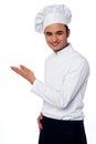 Here is the way to restaurant handsome chef greeting customers and directing them Stock Photos
