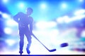 Hockey player shooting on goal in arena night ligh